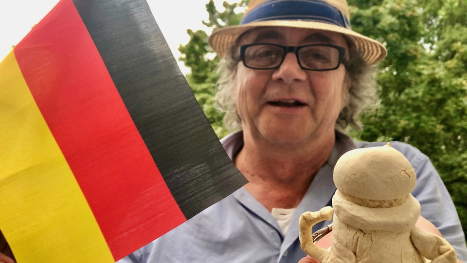 Jens Schellhass mit Pokal und Deutschlandflagge