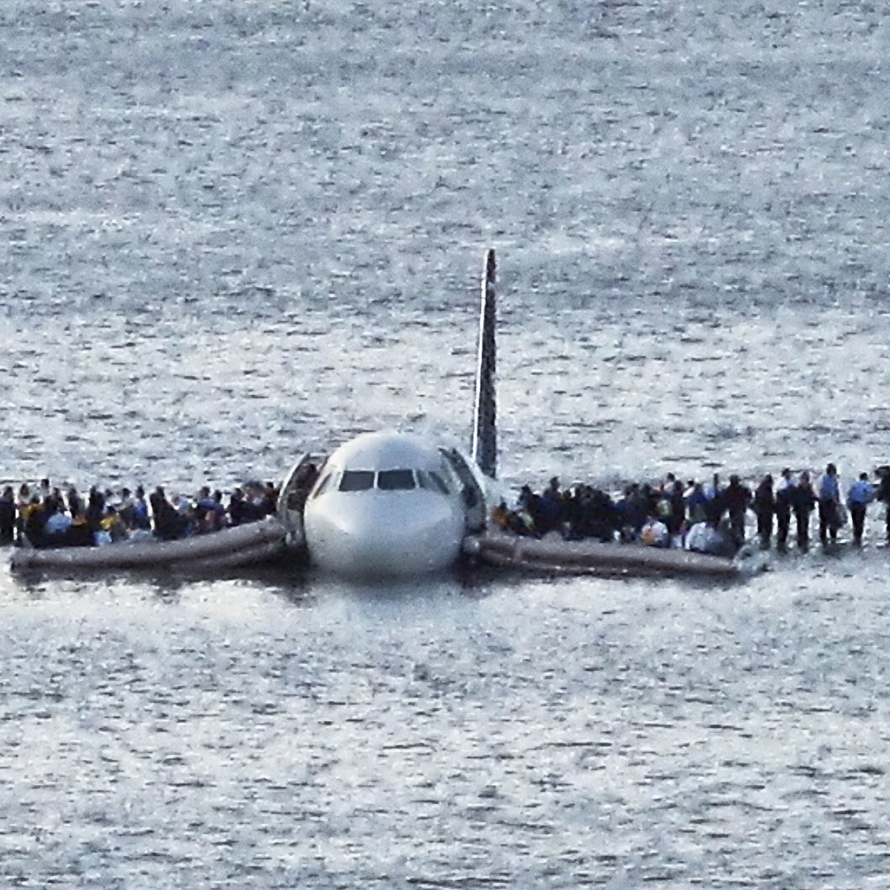 Passagiere stehen auf den Tragflächen einer notgewasserten Maschine auf dem Hudson River 2009